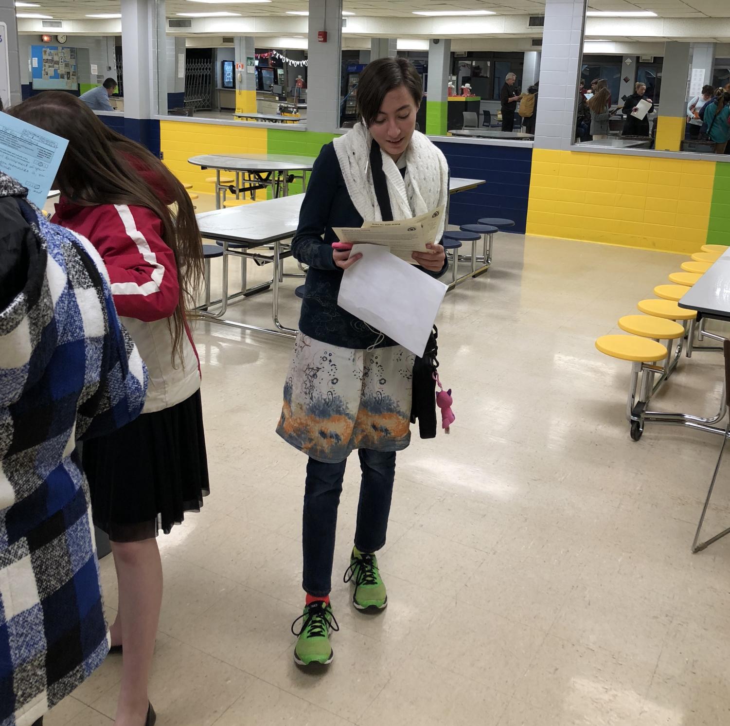 Freshman Sam McConaghy reviews the judges' evaluation sheets that advanced her to district level competition.